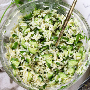 cucumber orzo salad in a glass bowl