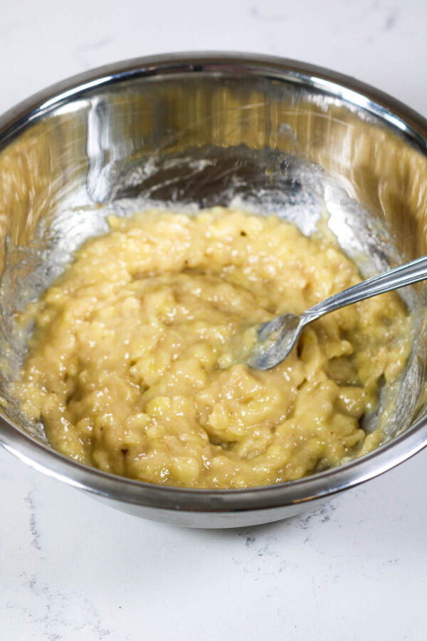 mashing bananas for greek yogurt banana muffins