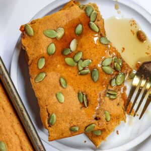 pumpkin sheet pan pancakes on a plate with a fork