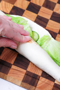 rolling up a turkey and cheese roll ups
