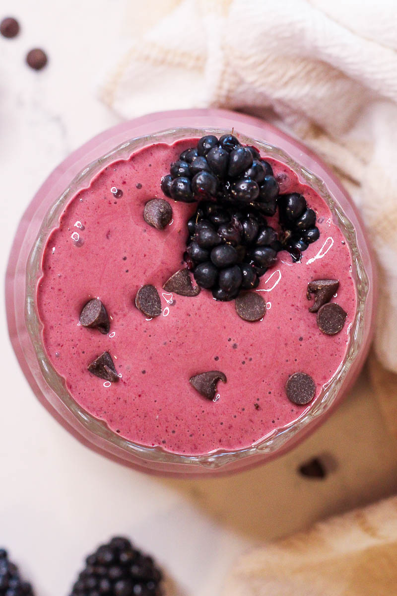 a chocolate blackberry smoothie garnished with blackberries and mini chocolate chips
