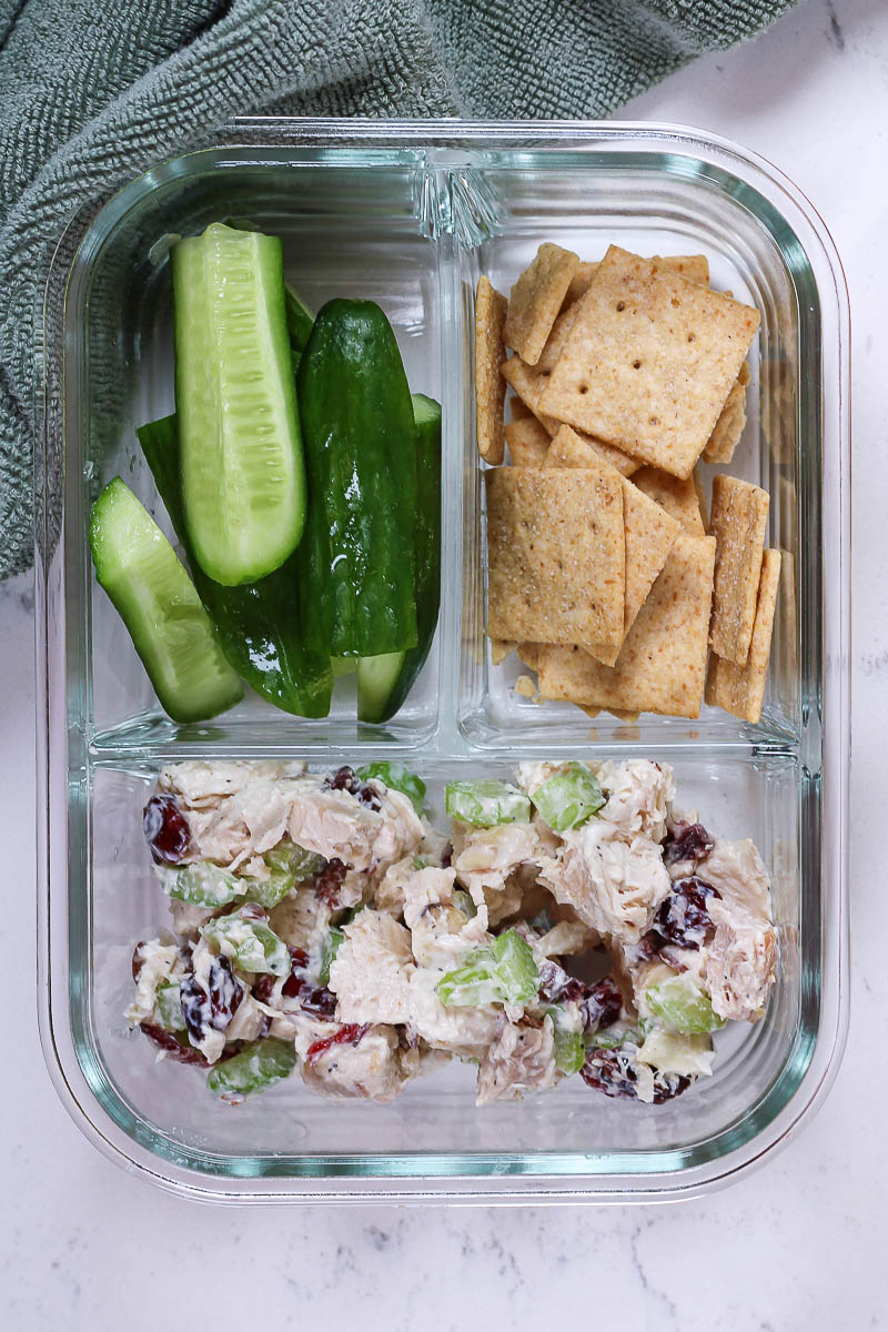 cranberry chicken salad in a meal prep glass divided container