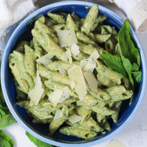 blue bowl of pasta with creamy pesto
