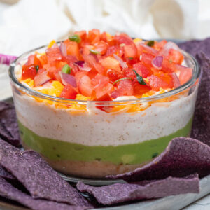 5 layer dip with blue corn tortilla chips