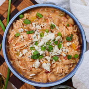 a bowl of buffalo chicken chili topped with blue cheese crumbles and green onion