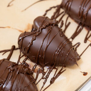 chocolate coated date hearts drizzled with chocolate