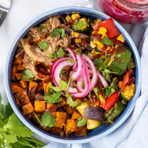vibrant, zesty bbq pulled pork bowl in a blue bowl
