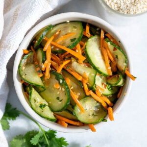 a small bowl of carrot and cucumber salad