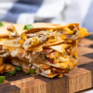 stacked chicken bacon ranch quesadillas with crispy cheese on the edges