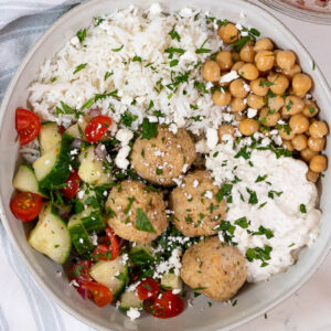 greek meatball bowl topped with feta and tzatziki