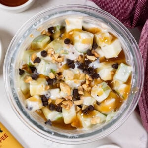 caramel apple cup with a high protein apple snickers salad with peanuts and caramel and mini chocolate chips